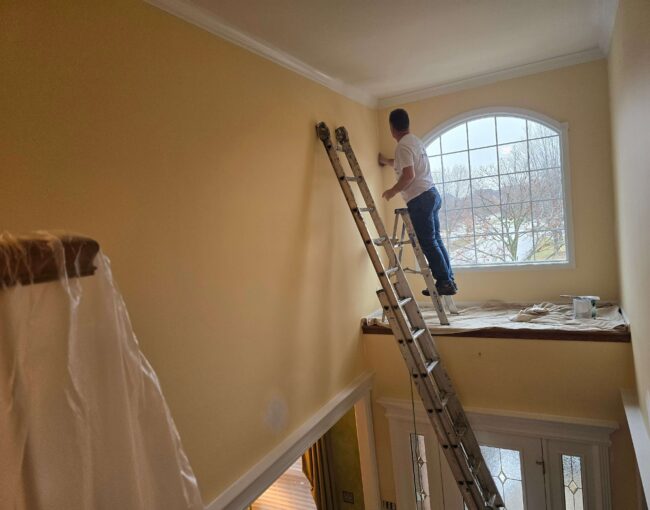A professional painter working on an interior wall