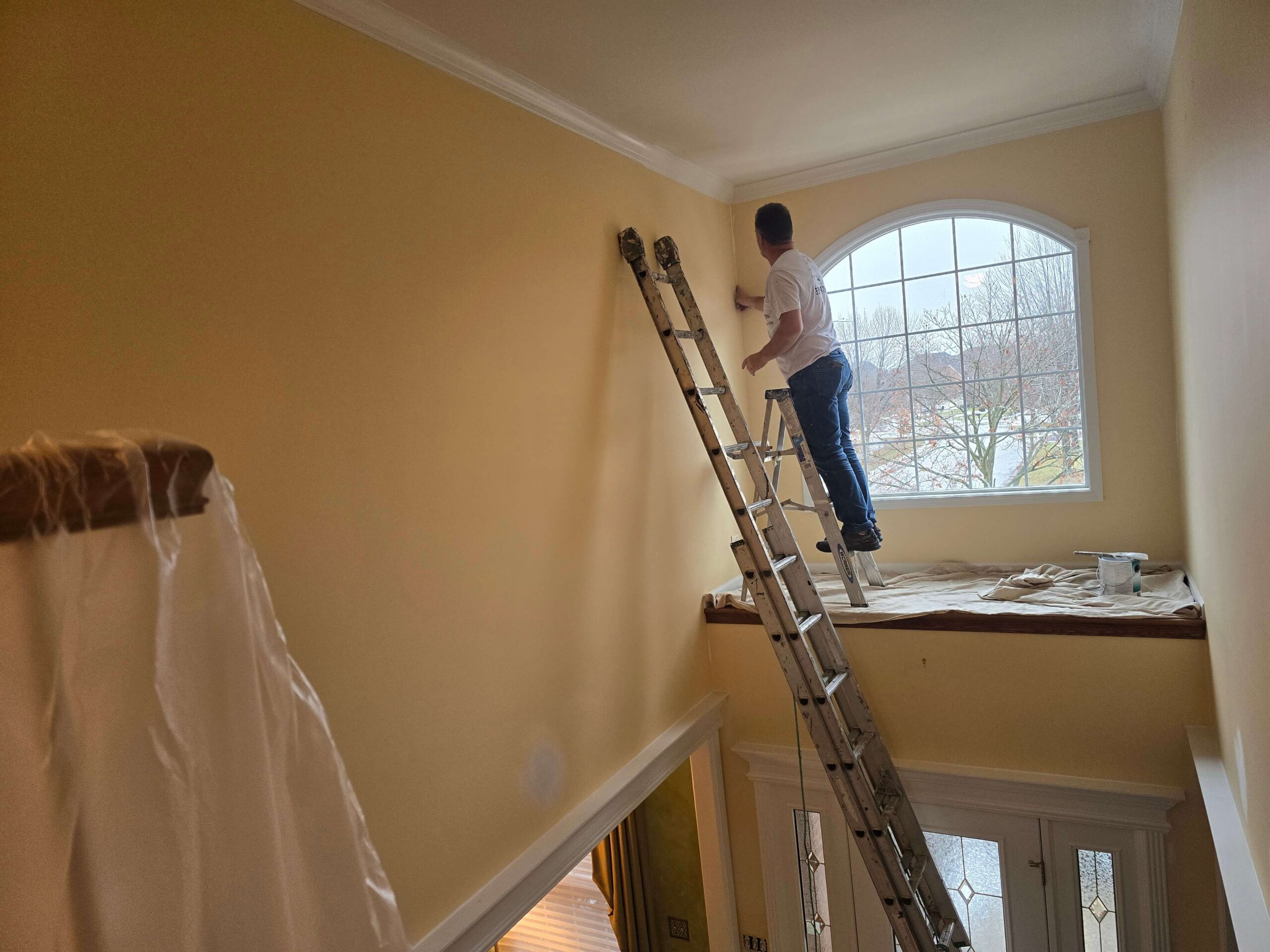 A professional painter working on an interior wall