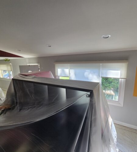 A professional interior painting expert working in a residential room.