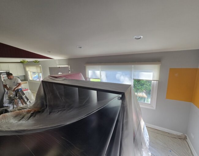 A professional interior painting expert working in a residential room.