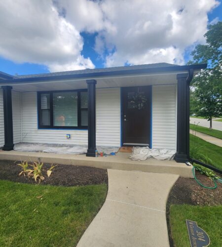 Lombard home exterior being painted with crisp white siding and black trim