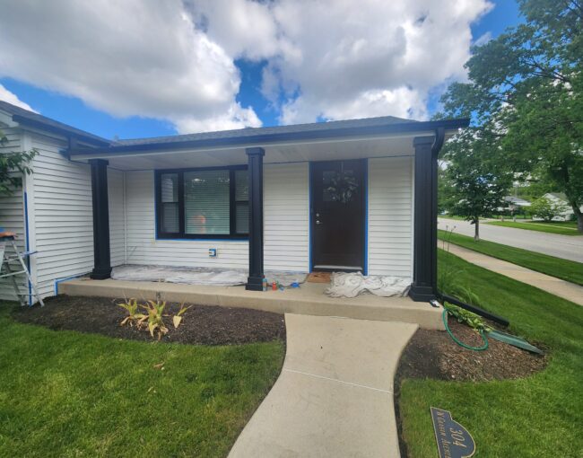 Lombard home exterior being painted with crisp white siding and black trim