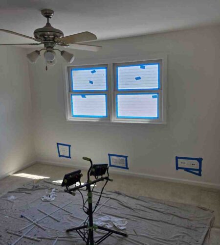 Small modern living space with seamless flat white ceiling and bright ambient lighting