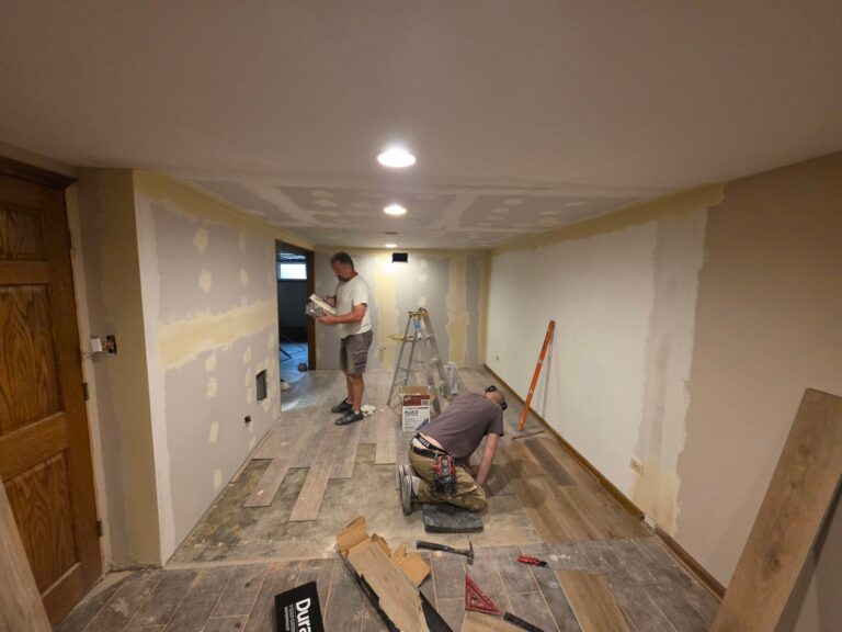 Basement walls and ceiling with patched and taped drywall being prepared for painting in Lemont, IL